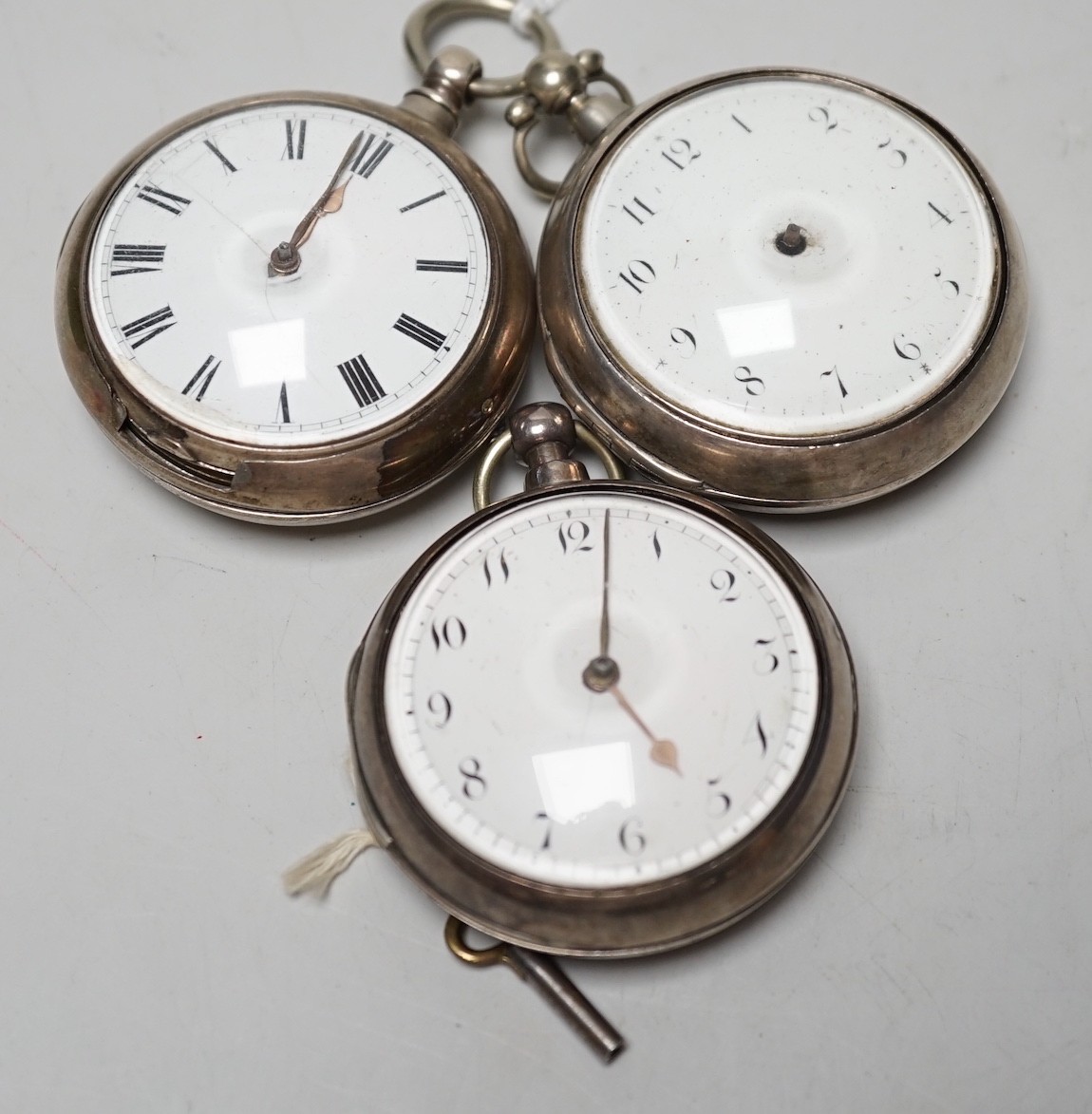 Three 19th century silver pair cased keywind verge pocket watches, by Graham, London, one signed WG, the other unsigned.